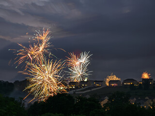 Fireworks over a residential area in USA on a summer evening.