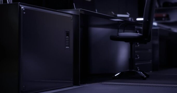 A modern office workspace features elegant furniture and dim lighting, creating a calm atmosphere for late night productivity. The desk is minimalist with a focused design.