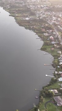 Florianopolis in Santa Catarina during a wonderful sunrise. Mo&ccedil;ambique Beach in aerial view, vertical video.