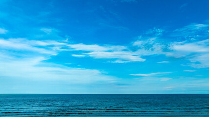 Fototapeta premium Nature of the ocean and blue sky Summer with sunshine, sandy beaches, clear blue waters sparkling against the blue sky. on an island with good ecology and environment Background for summer vacation