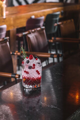 Fruit Cocktail with Ice and Rosemary Garnish in Clear Glass - Citrus and Berry Cocktail with Rosemary and Ice Cubes – Close-Up View