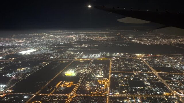 View from a plane flying over Dubai at night. 