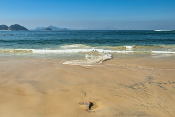 Rio de Janeiro, Brazil, May 19, 2025: Copacabana Beach is a beach located in the Copacabana neighborhood, in the South Zone of the city of Rio de Janeiro, Brazil. Beautiful blue skies and golden sand
