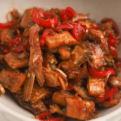 Stir fried salted fish with onion, garlic and chili on the table