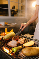 A cheerful summer barbecue gathering with friends and family grilling meat outdoors, enjoying food, laughter, and togetherness in a sunny garden.