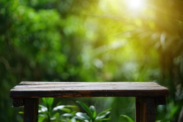 Naklejka premium Rustic wooden tabletop in a lush green garden setting with sunlight