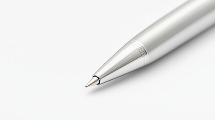 Close-up view of a sleek, silver ballpoint pen against a plain white background. Ideal for illustrating writing, signing documents, or office supplies themes.