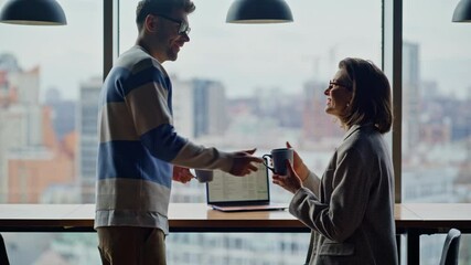 Colleague bringing tea businesswoman at panoramic cityscape windows coworking - Powered by Adobe