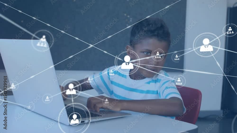 Poster boy gesturing at laptop and activating technology network icons while typing for visualizing data
