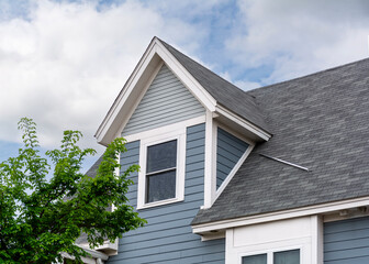 Elegant gabled dormer on a slanted roof a house in Brighton, Massachusetts, USA
