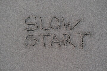 Slow Start – Handwritten Message on Volcanic Sand