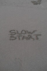 Slow Start – Handwritten Message on Volcanic Sand