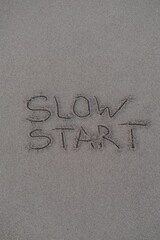Slow Start – Handwritten Message on Volcanic Sand
