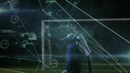Goalkeeper scanning floodlit soccer pitch noticing overlay showing guiding diving deflecting shot - Powered by Adobe