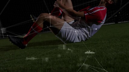 Soccer player gripping injured knee and curling into fetal position with pulsing data overlays - Powered by Adobe