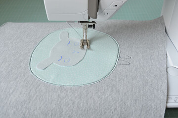 Cute sheep applique working process: sewing machine and fabric pieces