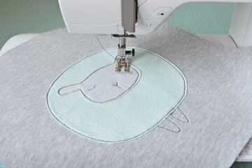 Cute sheep applique working process: sewing machine and fabric pieces