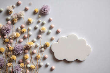 A white cloud with a bunch of flowers and candy on the ground