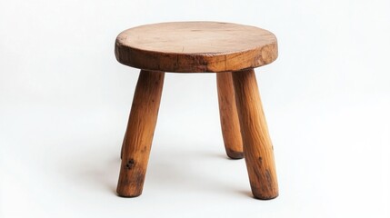 Wooden stool with three legs on white background, rustic and simple design