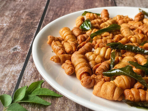 Kuih siput homemade close up. Traditional popular snack with copy space background. Stock photo.