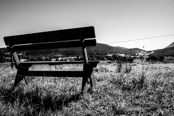 Rustic wooden bench overlooking scenic mountain valley 