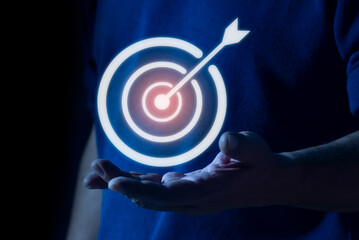 Businessman holding virtual target icon for business purpose. set up business objective target goal...