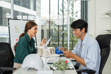 ESG and Sustainability. Engineers collaborating on eco-friendly building design.