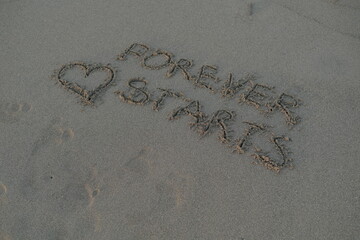 Forever Starts Message on Volcanic Sand with Heart Symbol