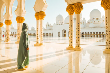 Abu Dhabi, UAE - april 25th, 2025: woman traveler wear stylish abaya sightseeing Sheikh Zayed Grand Mosque in Abu Dhabi on beautiful sunset. Free entrance mosque visit entrance famous destination