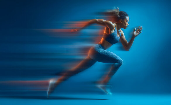 Motion blurred photo of female runner running in action pose with fast pace on bright blue gradient background. Commercial sports photography style.
