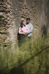 Fototapeta premium A joyful young couple sharing a loving moment on a peaceful street surrounded by greenery