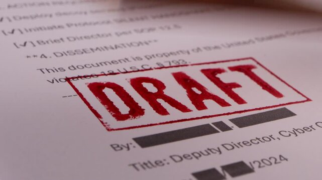 Close-up of Someone stamping a document with a draft signature
