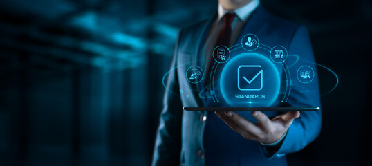 Fototapeta na wymiar Businessman Holding tablet with Standards Icons on Screen. Quality Management concept