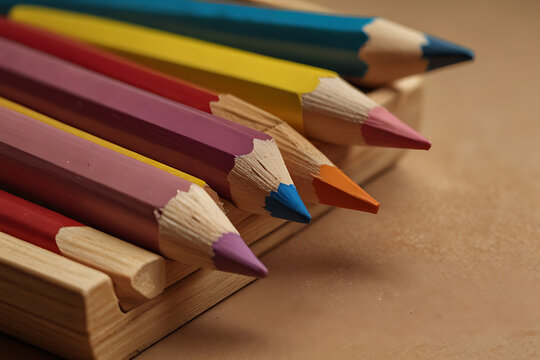 A vibrant group of colorful sharpened drawing pencils on a white or wooden background.