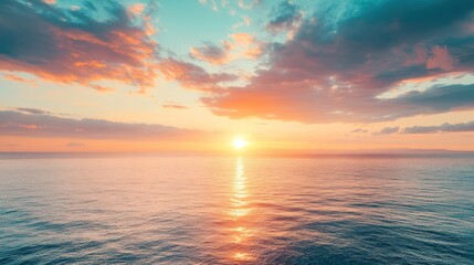 Majestic sunrise paints sky with vibrant hues over tranquil ocean waters