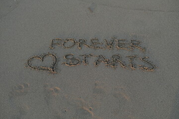 Forever Starts Message on Volcanic Sand with Heart Symbol