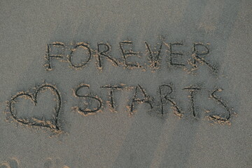 Forever Starts Message on Volcanic Sand with Heart Symbol