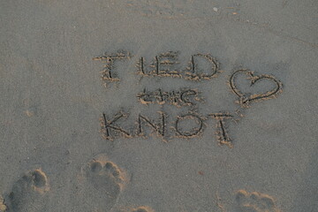 Tied The Knot Message on Volcanic Sand with Heart Symbol