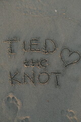 Tied The Knot Message on Volcanic Sand with Heart Symbol