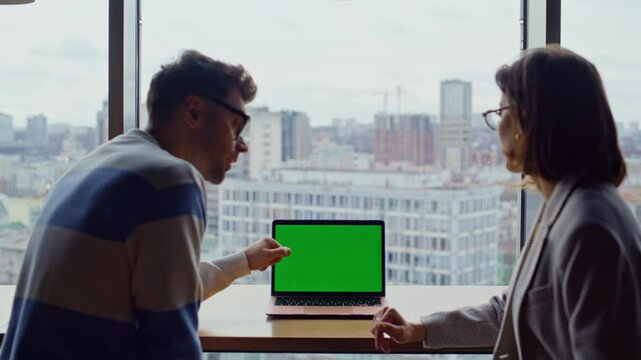 Coworkers pointing mockup computer at windows office closeup. Partners working