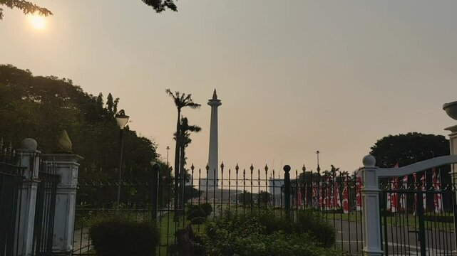 Jakarta, Mei 28, 2025. The tourist area of ​​the Monas Monument. view of indonesia national monument with sun and dark clouds vertical and landscape footage 4k.