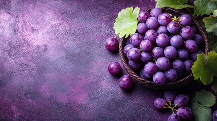 Elegant Still Life Featuring Ripe Purple Grapes in Woven Basket on Textured Surface Backdrop, Ideal for Food or Agriculture Themed Graphics