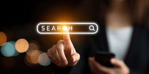 Digital Exploration: A hand points towards a glowing search bar, symbolizing the quest for information and the limitless potential of the digital realm.