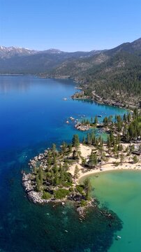 Lake Tahoe - Vertical Aerial Rotation Around San Harbor Beach with Clear Blue Waters and Kayakers 