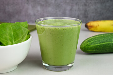 Serving green smoothie in a glass cup.