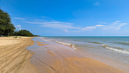 beautiful beach views, blue skies, and lush green trees