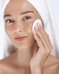 Closeup of Woman Cleansing Face With Cotton Pad After Shower Routine