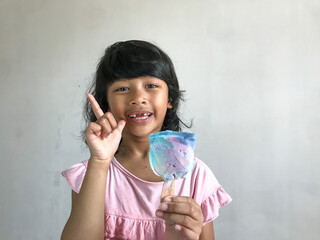 A little girl is eating an ice cream