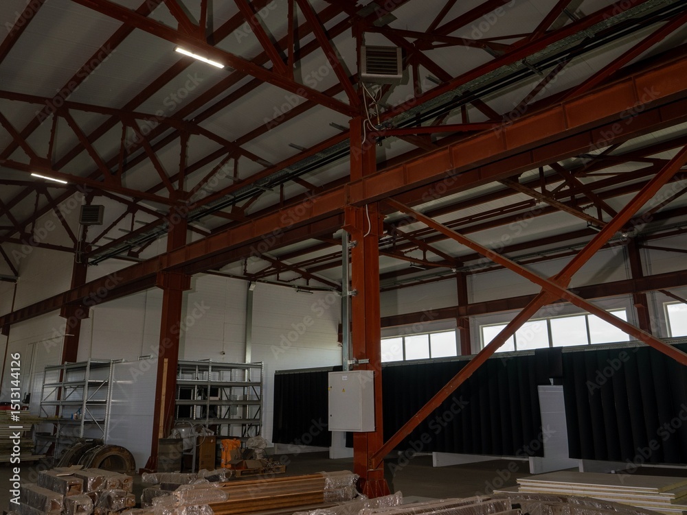 Poster a large industrial building with a lot of empty space and a lot of metal