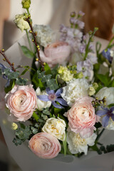 Elegant bouquet with pink and white ranunculus and purple flowers